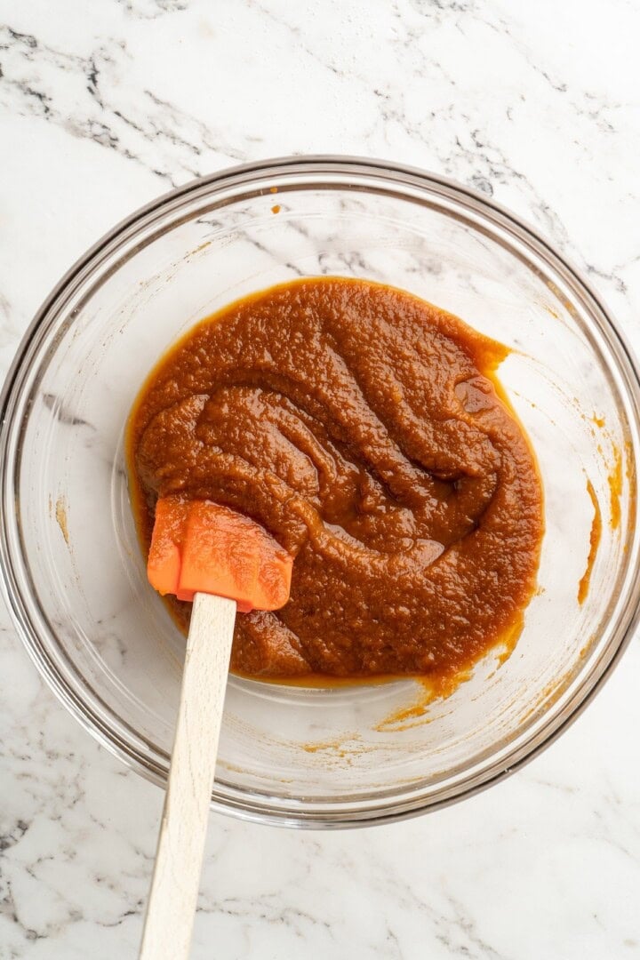 Pumpkin filling in mixing bowl with rubber spatula