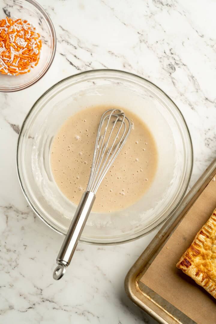 Icing in bowl with whisk