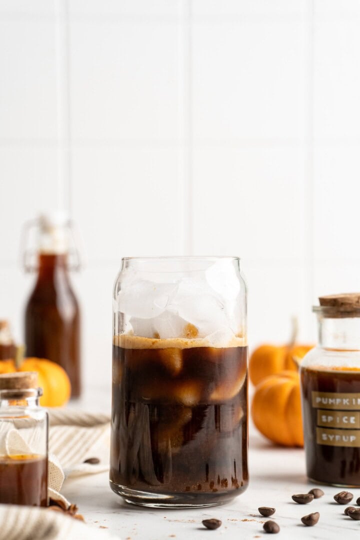 Espresso and syrup in glass with ice for pumpkin spice latte