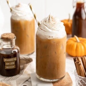 Two pumpkin spice lattes with vegan whipped cream