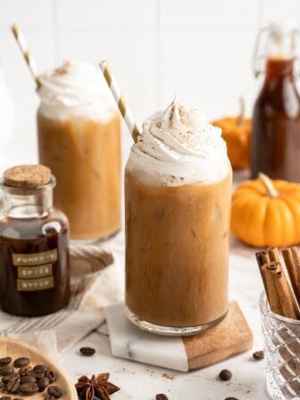 Two pumpkin spice lattes with vegan whipped cream