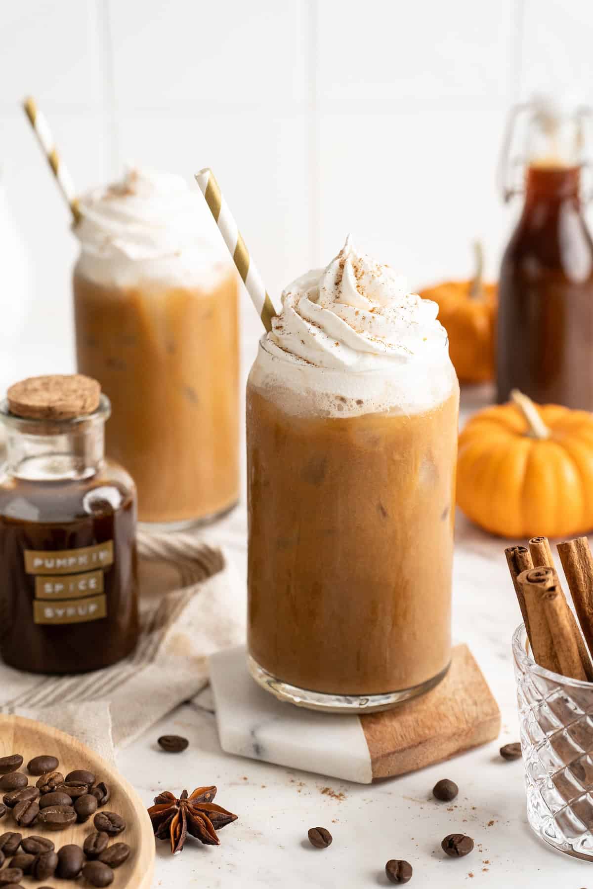 Two pumpkin spice lattes with vegan whipped cream