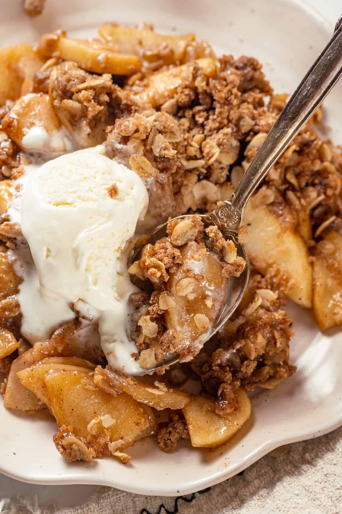 Vegan apple crisp on plate with ice cream