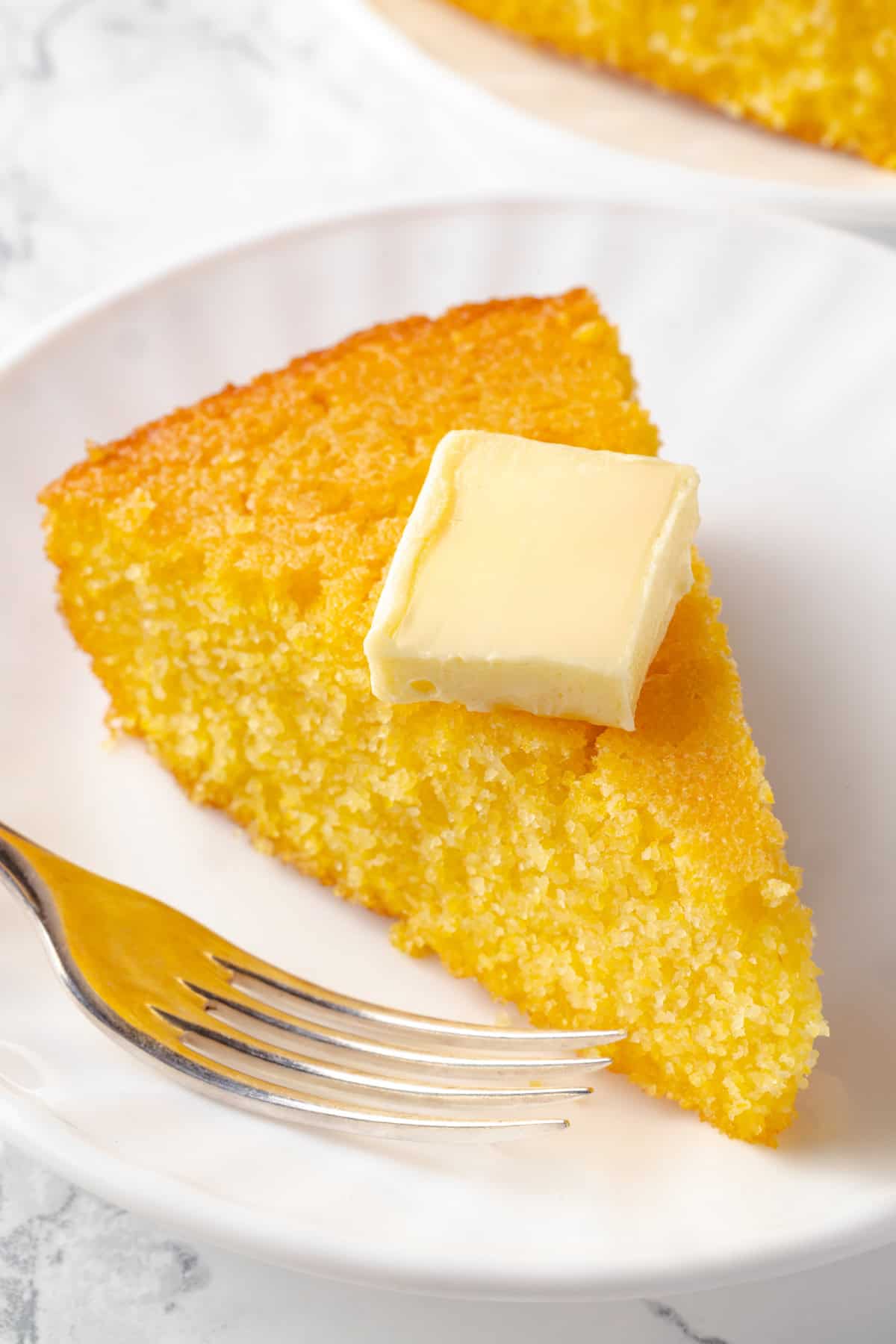 Slice of corn pone with pat of butter