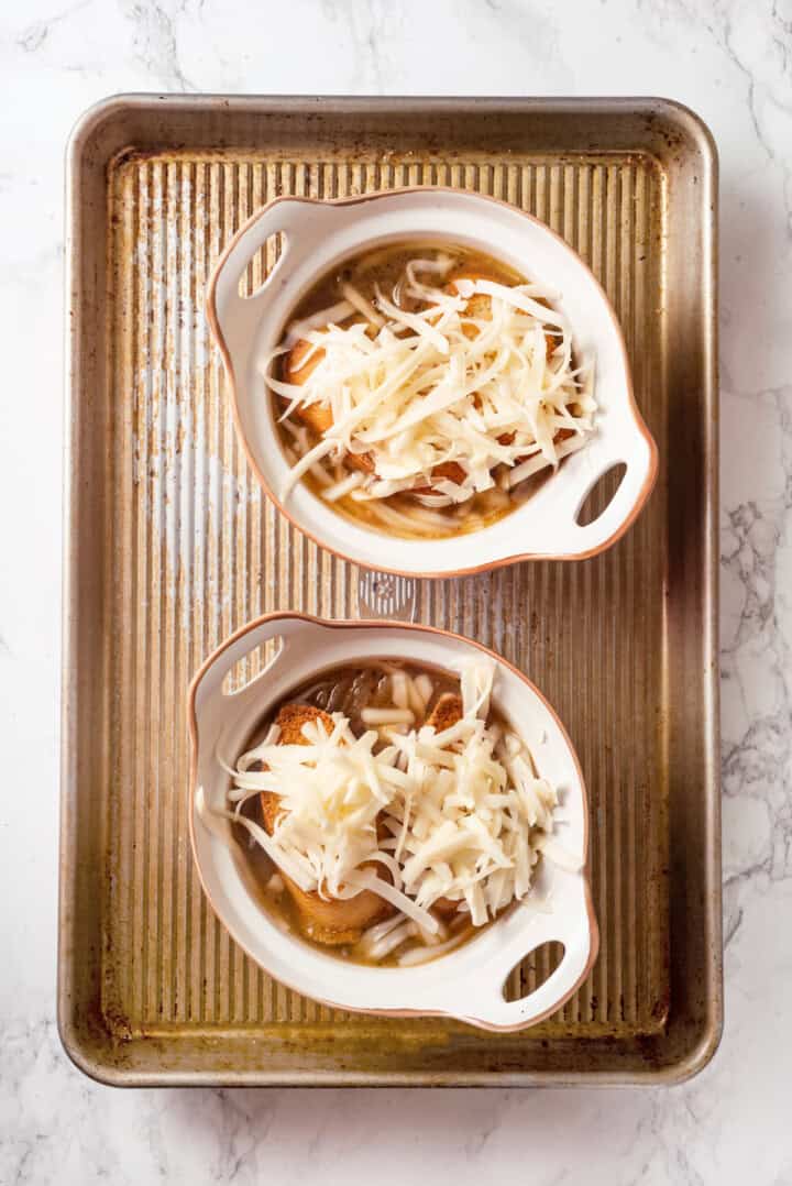 Overhead view of French onion soup in bowls before baking