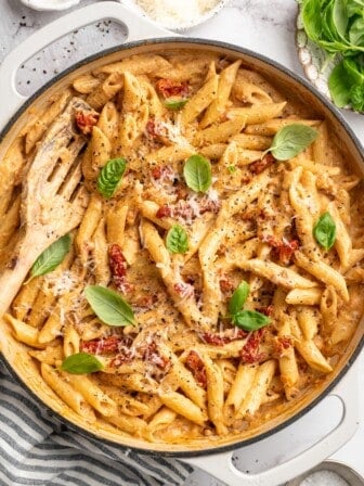 Overhead view of marry me pasta in skillet with slotted spoon