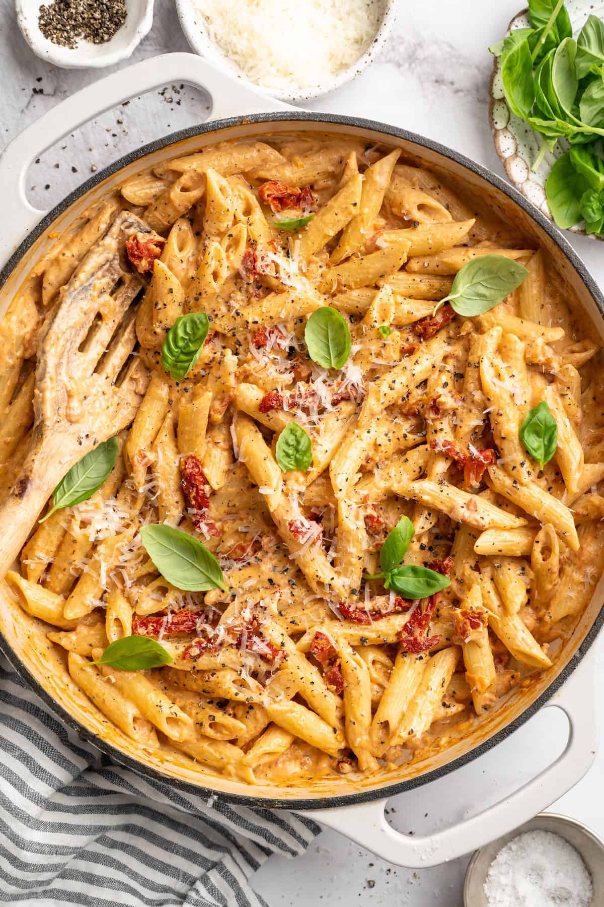 Overhead view of marry me pasta in skillet with slotted spoon