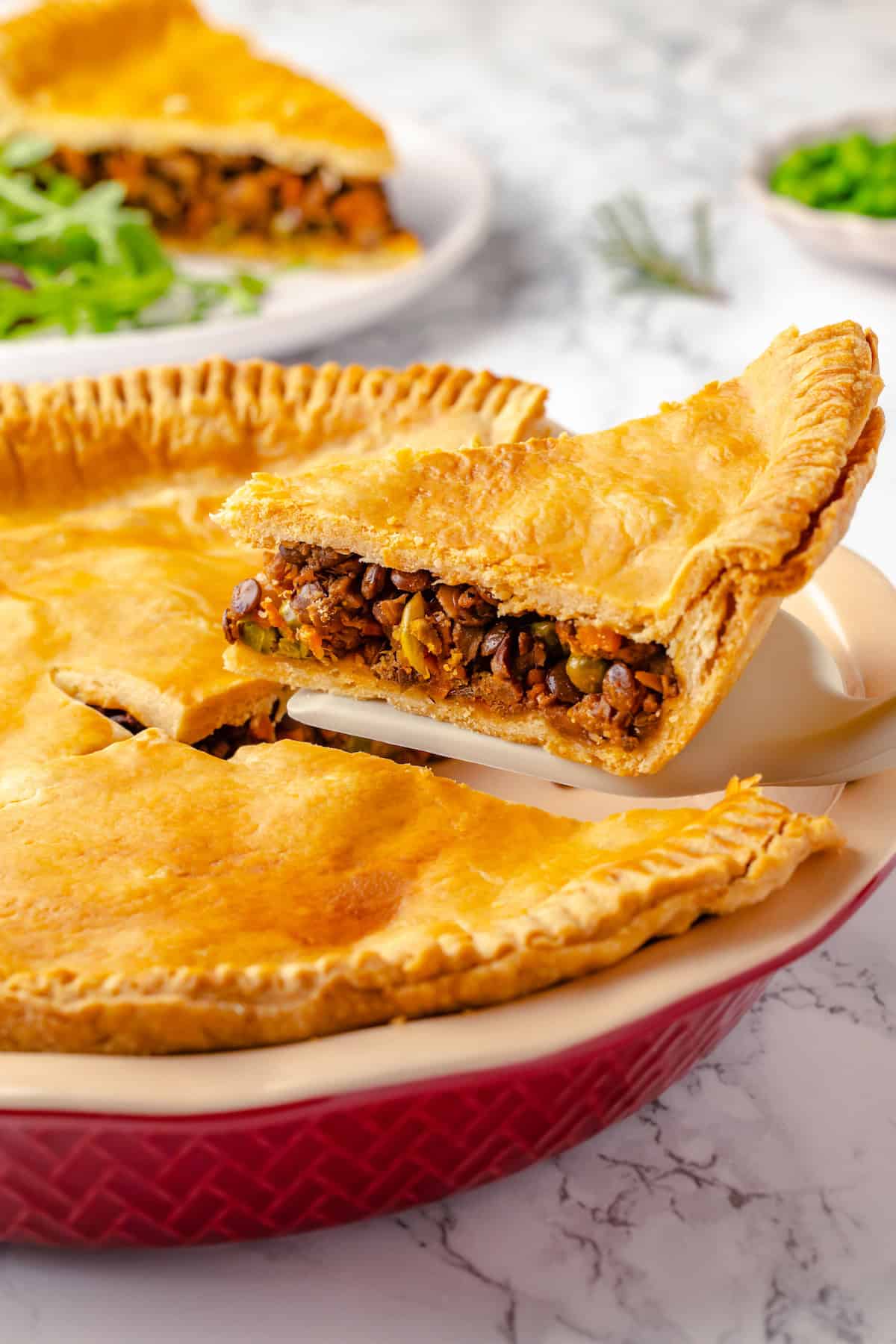 Lifting slice of tourtière from pan