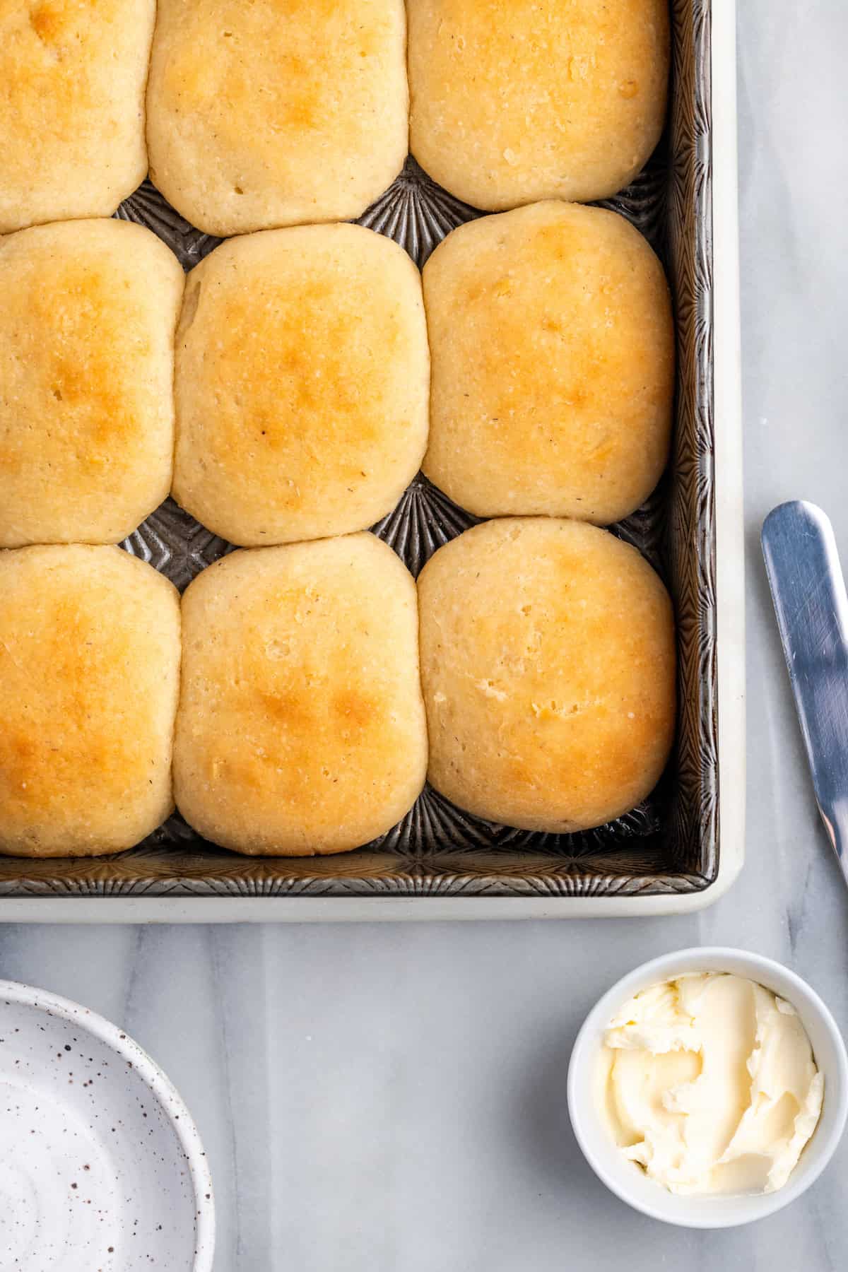 Overhead view of baked gluten-free dinner rolls in pan