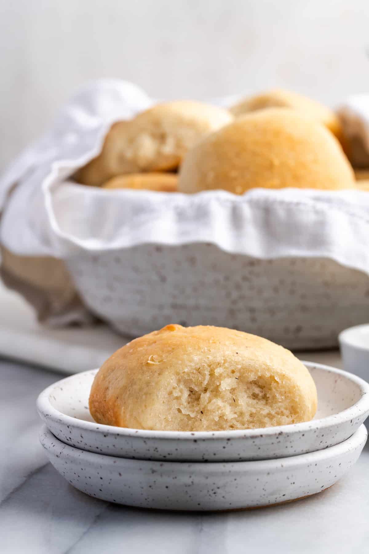 Vegan gluten-free dinner rolls on plate and in bowl