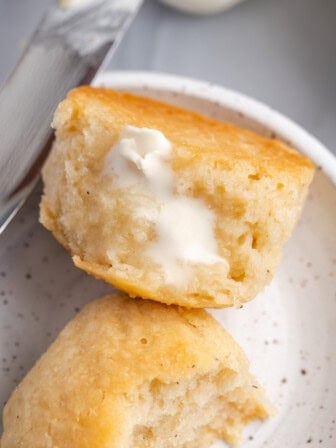 Overhead view of tender gluten-free dinner rolls with butter