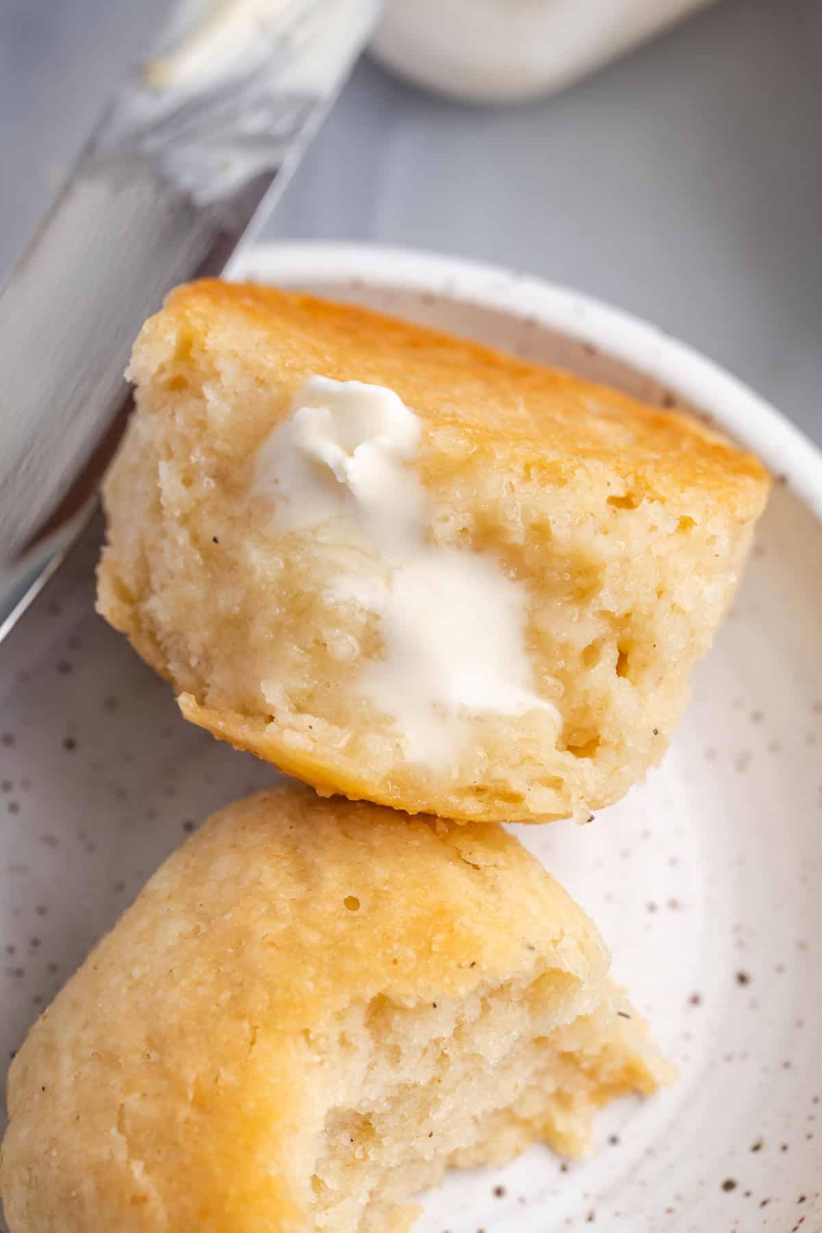 Overhead view of tender gluten-free dinner rolls with butter