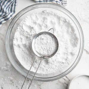 Homemade powdered sugar in bowl with sifter