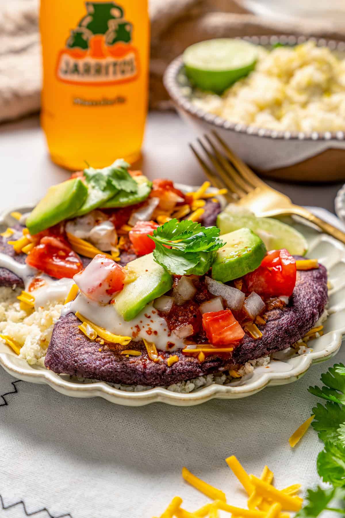 Vegan tlacoyos on a plate with fixings.