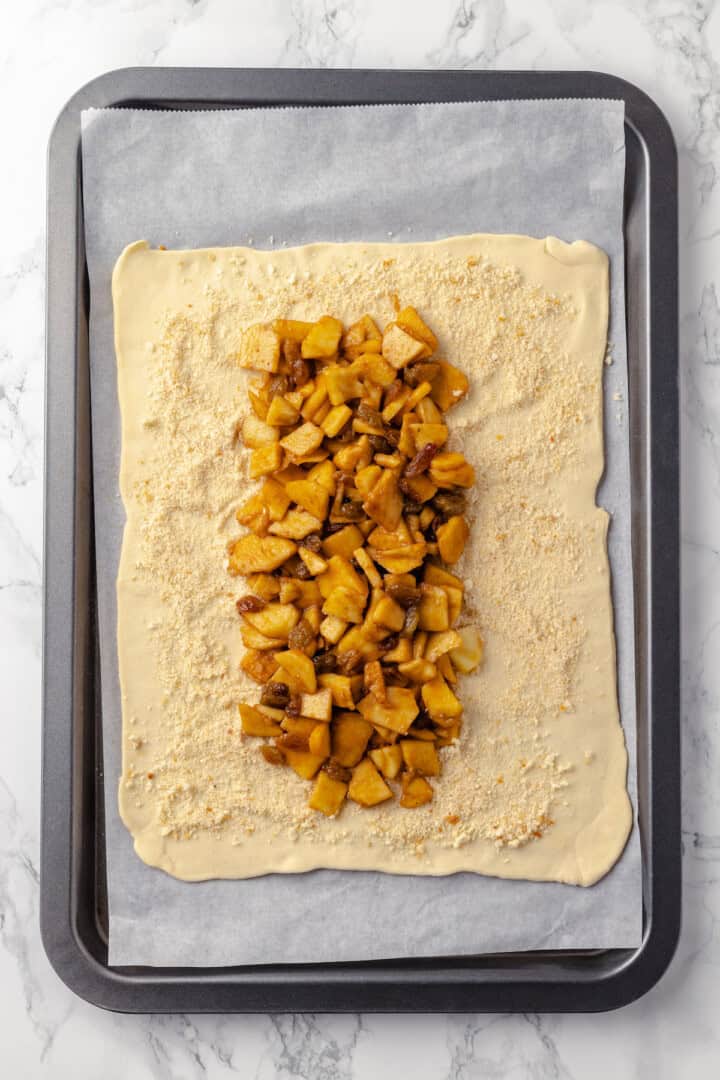 Overhead view of filling added to puff pastry sheet