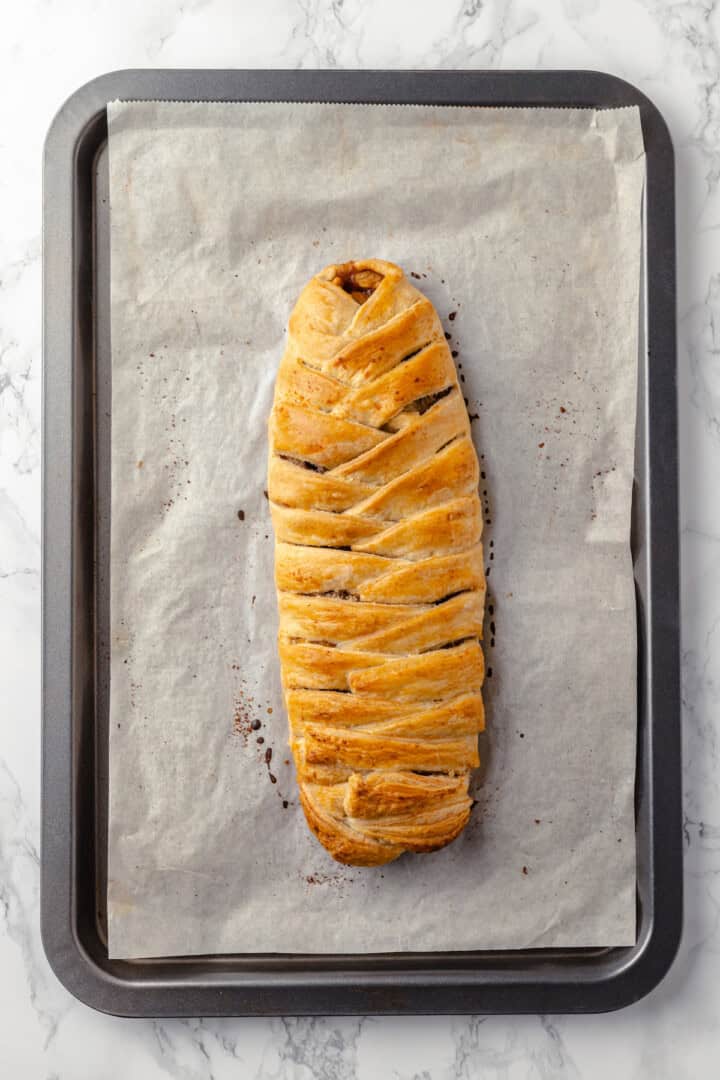 Overhead view of apple strudel on parchment-lined baking sheet