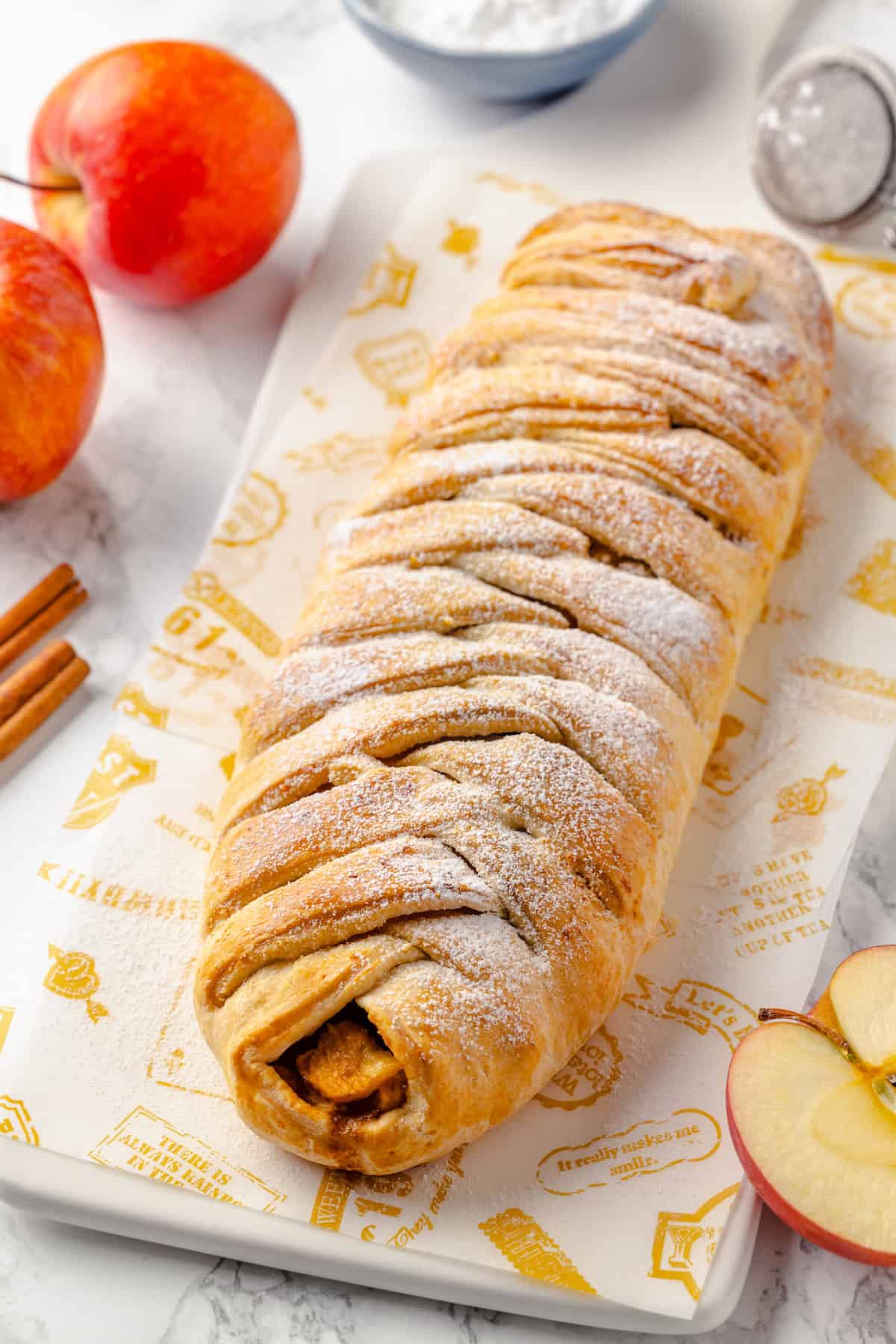 Whole apple strudel on cutting board