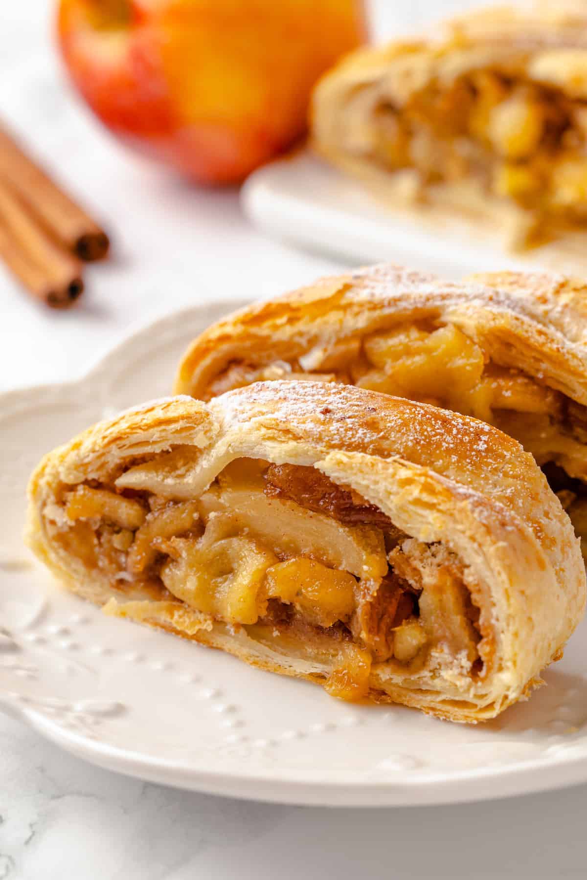 Two slices of vegan apple strudel on plate