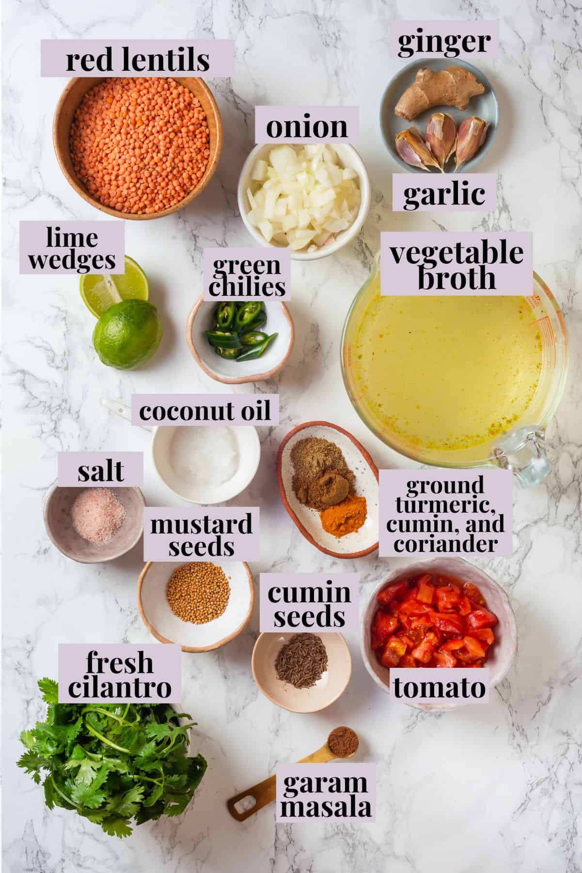 Overhead view of red lentil dal ingredients with labels