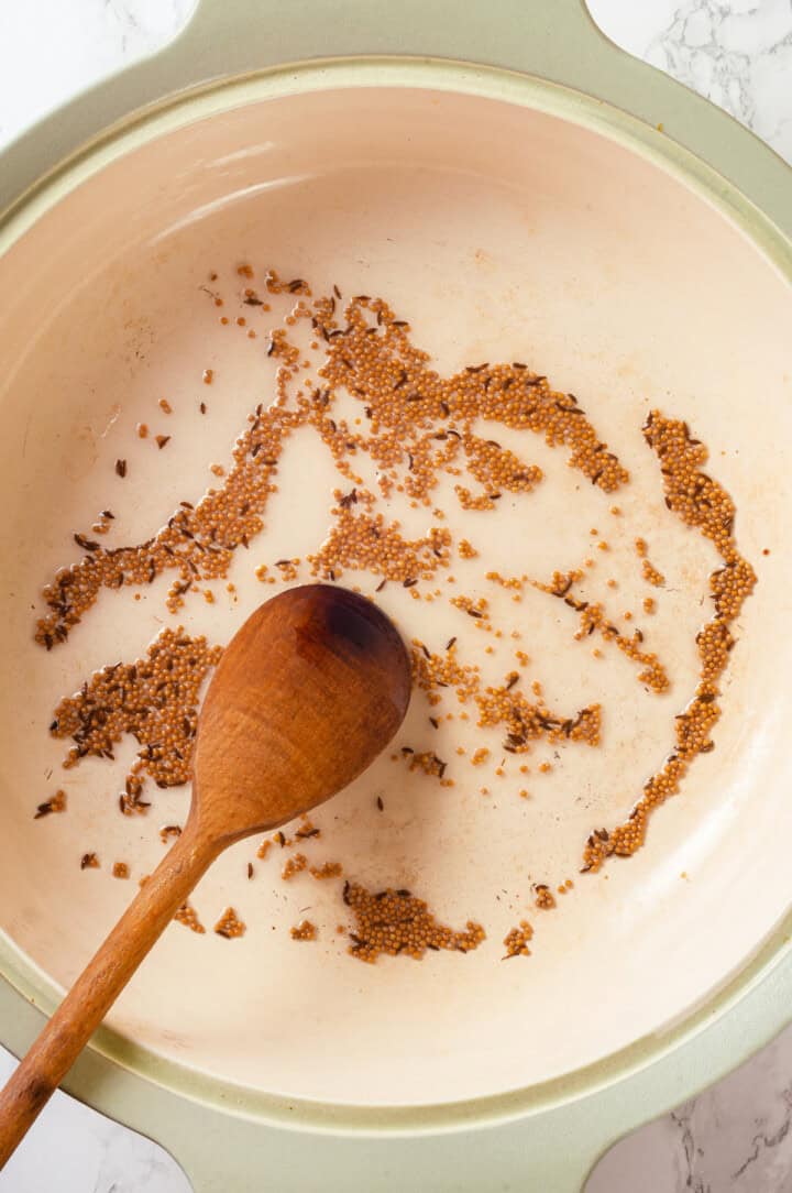 Cooking cumin and mustard seeds in oil