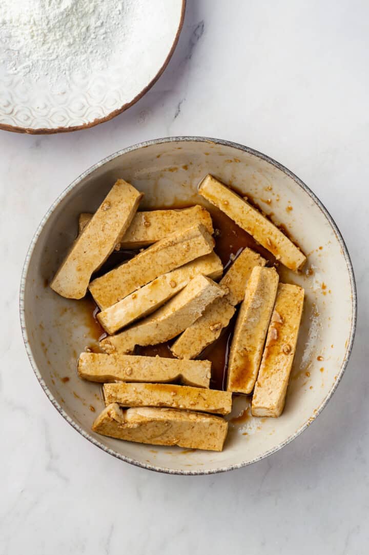 Tofu marinating in soy sauce and sesame oil