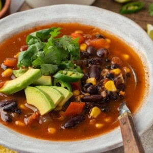 Bowl of vegan taco soup with cilantro and avocado