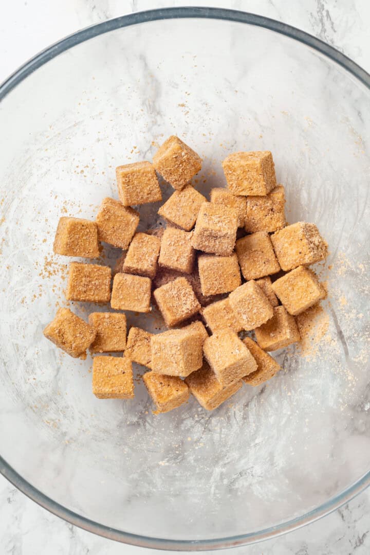 Tofu in bowl with cornstarch coating