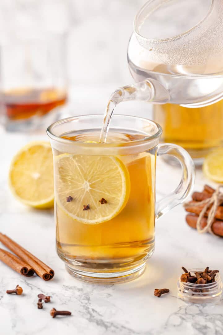 Pouring hot water into mug for hot toddy