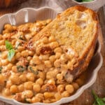 Slice of bread in bowl of marry me chickpeas