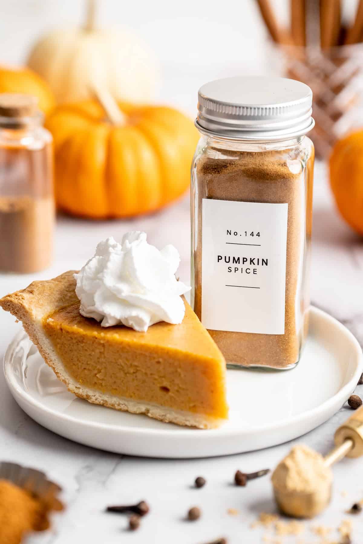 Pumpkin pie spice on plate with pumpkin pie slice