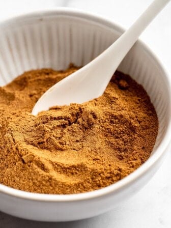 Bowl of pumpkin pie spice with spoon