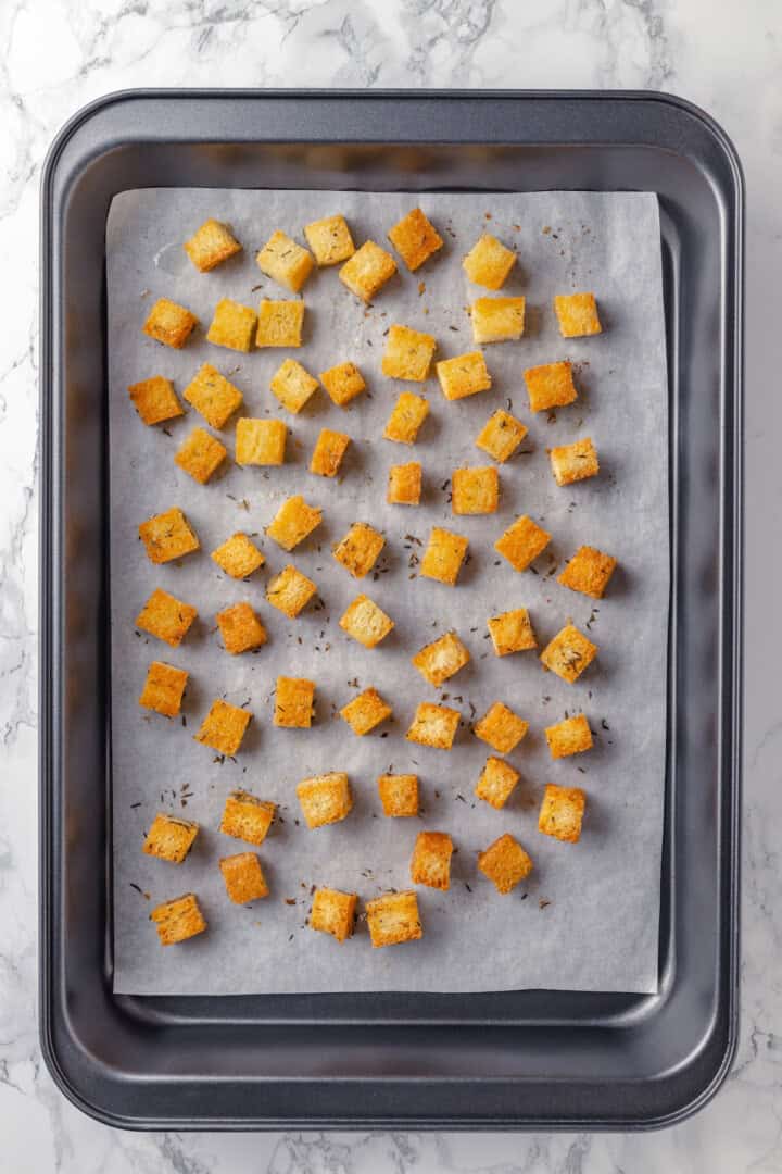 Overhead view of croutons on sheet pan