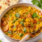 Bowl of vegetable korma with spoon