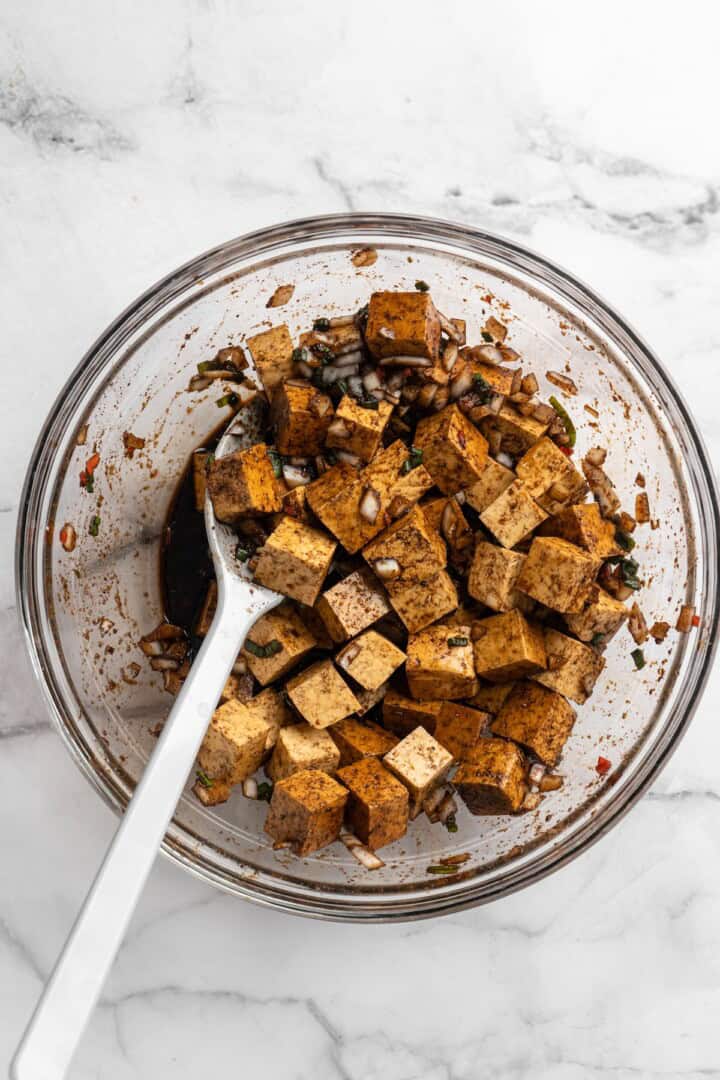 Stirring tofu in marinade