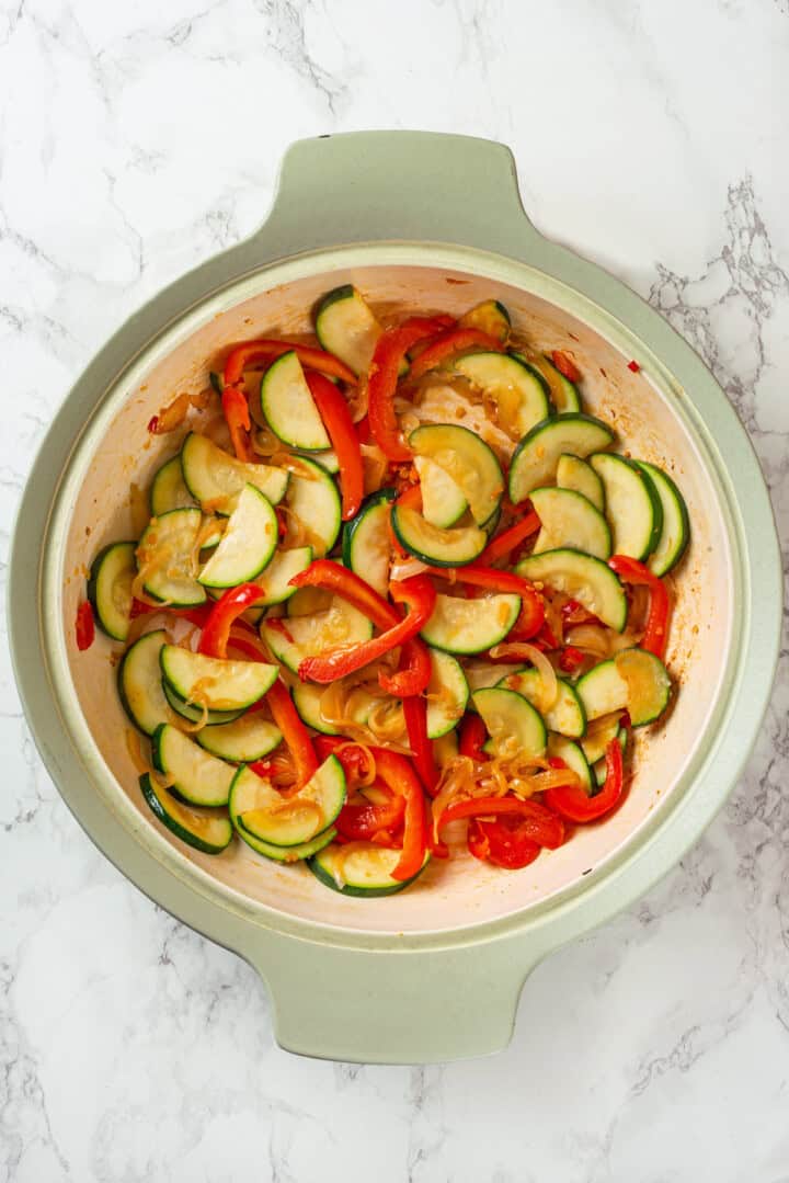 Stir fried zucchini and peppers in skillet