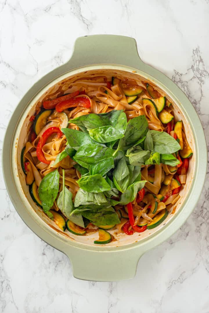 Basil added to skillet of drunken noodles