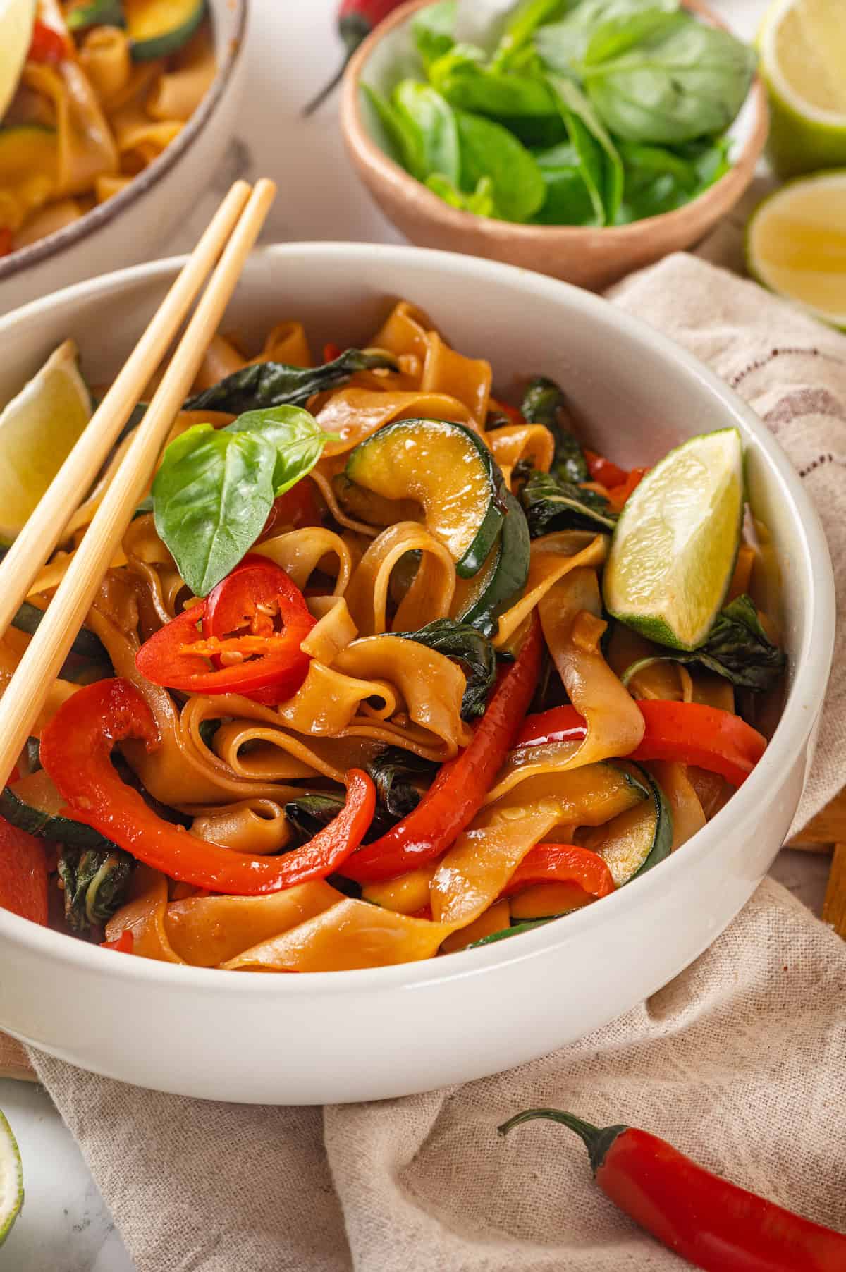 Bowl of vegan drunken noodles with chopsticks