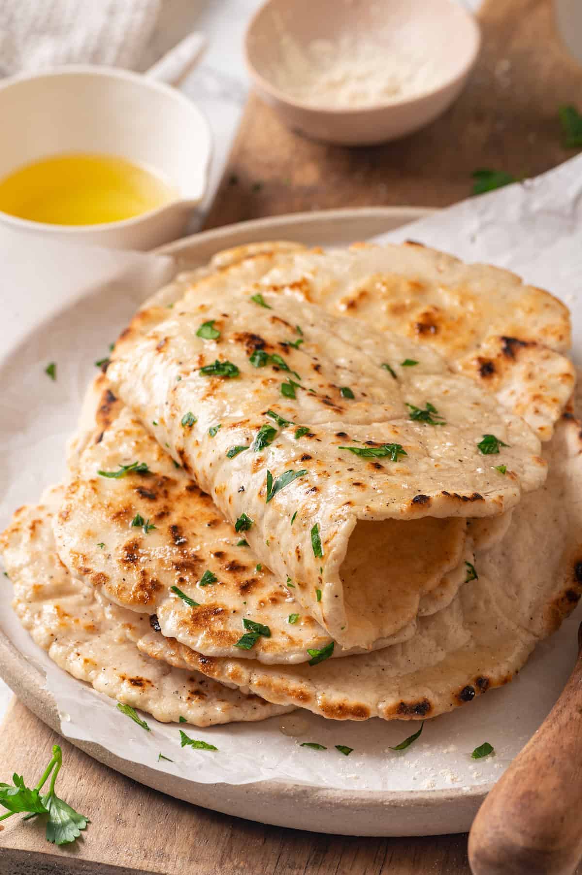 Homemade gluten-free naan stacked on plate