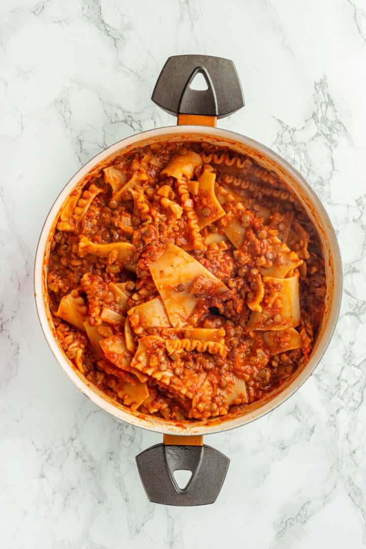 Overhead view of pasta and sauce in skillet