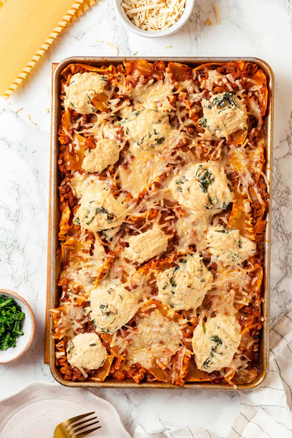 Overhead view of sheet pan lasagna with crispy edges