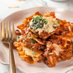 Crispy sheet pan lasagna on plate with fork