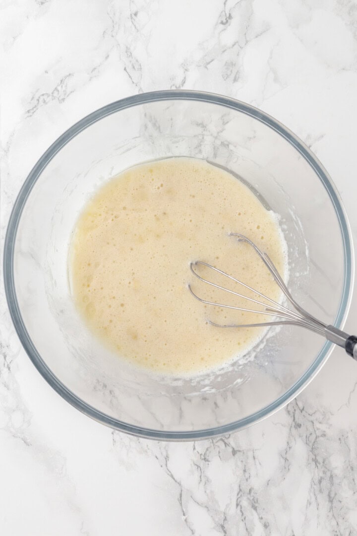 Wet ingredients in mixing bowl with whisk