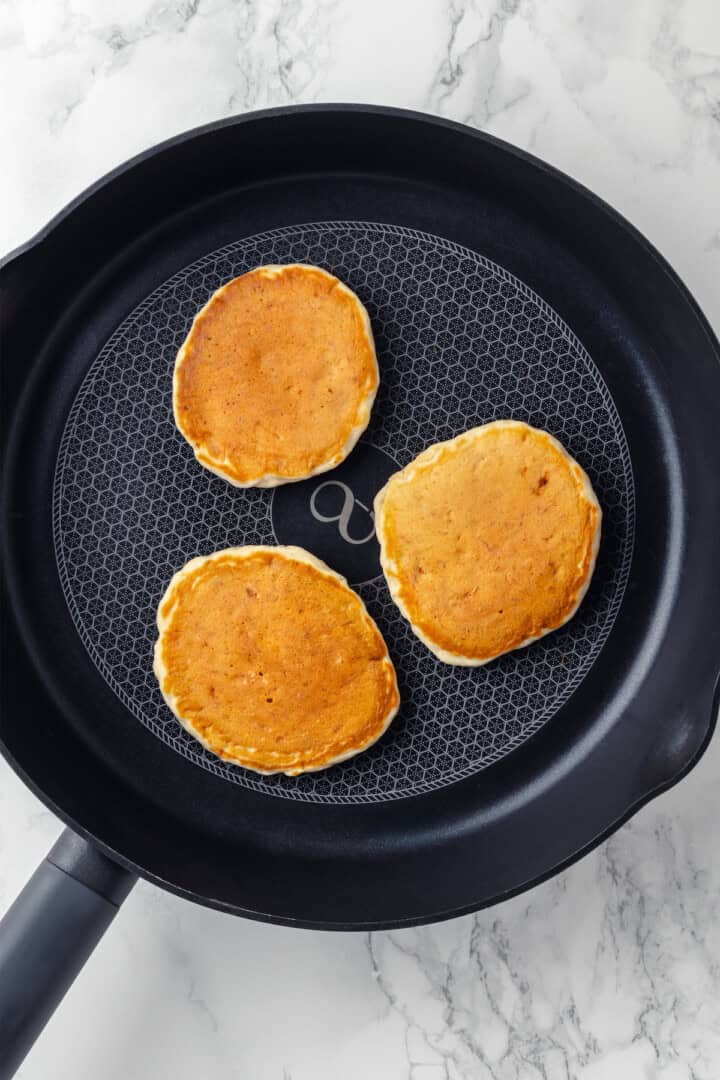 Overhead view of banana pancakes in skillet