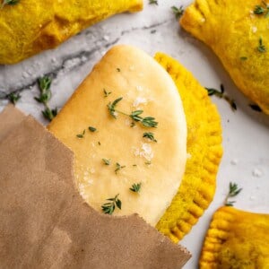 Overhead view of vegan Jamaican patties in paper bag