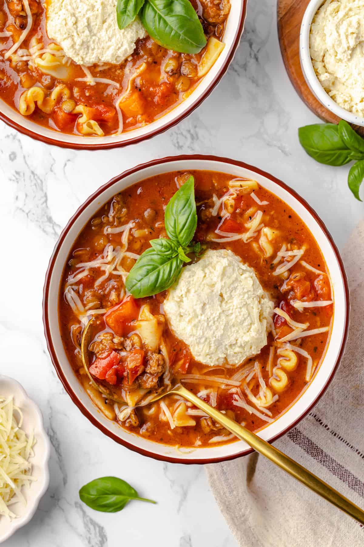 Overhead view of vegan lasagna soup in 2 bowls