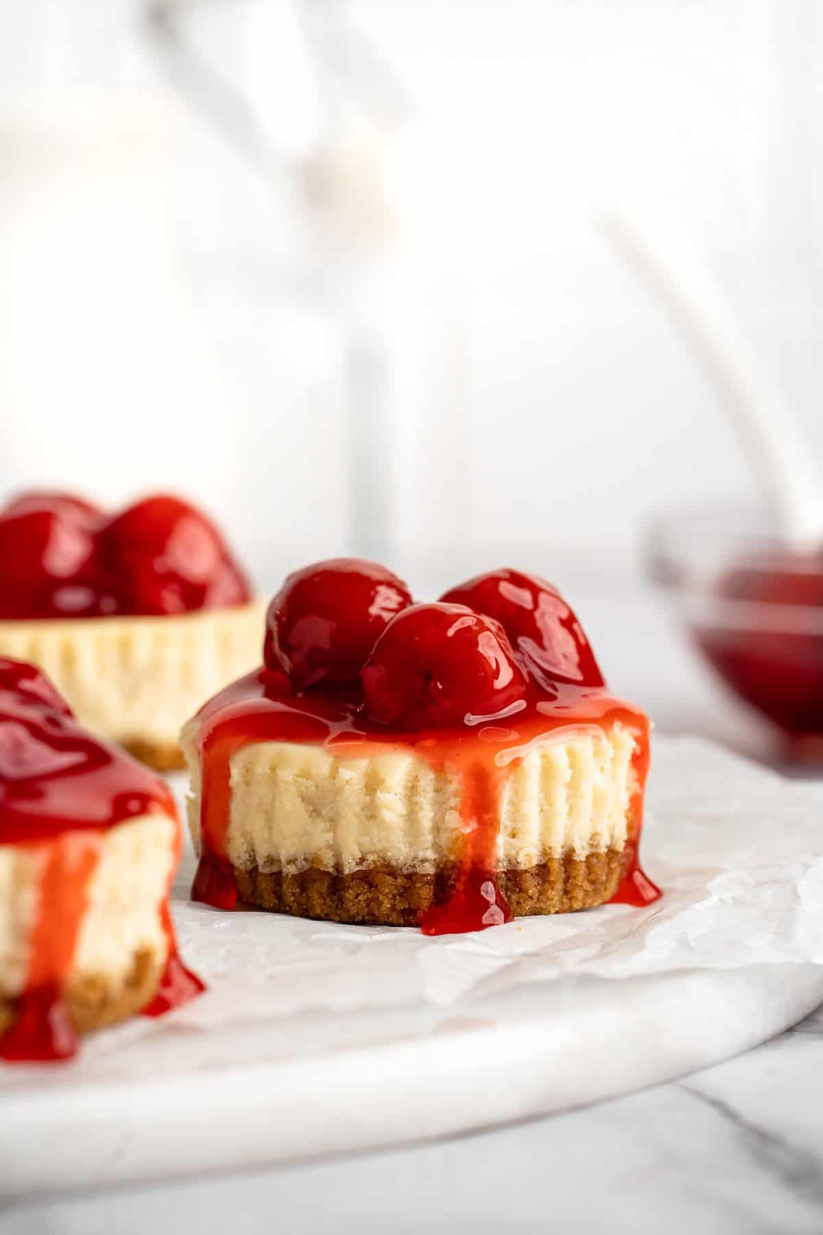 Mini cheesecakes topped with cherries