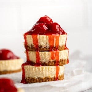 Stack of 3 mini cheesecakes with cherry topping