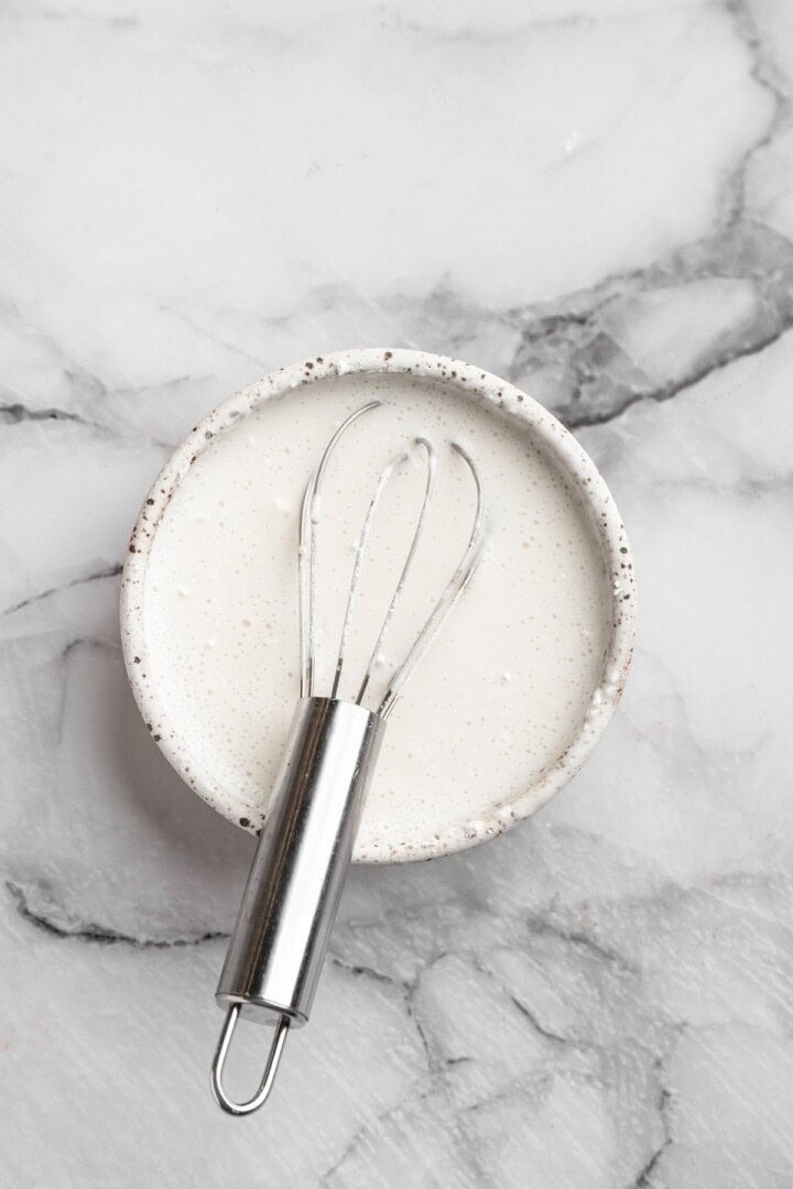 Mixing coconut cream and cornstarch in small bowl with whisk