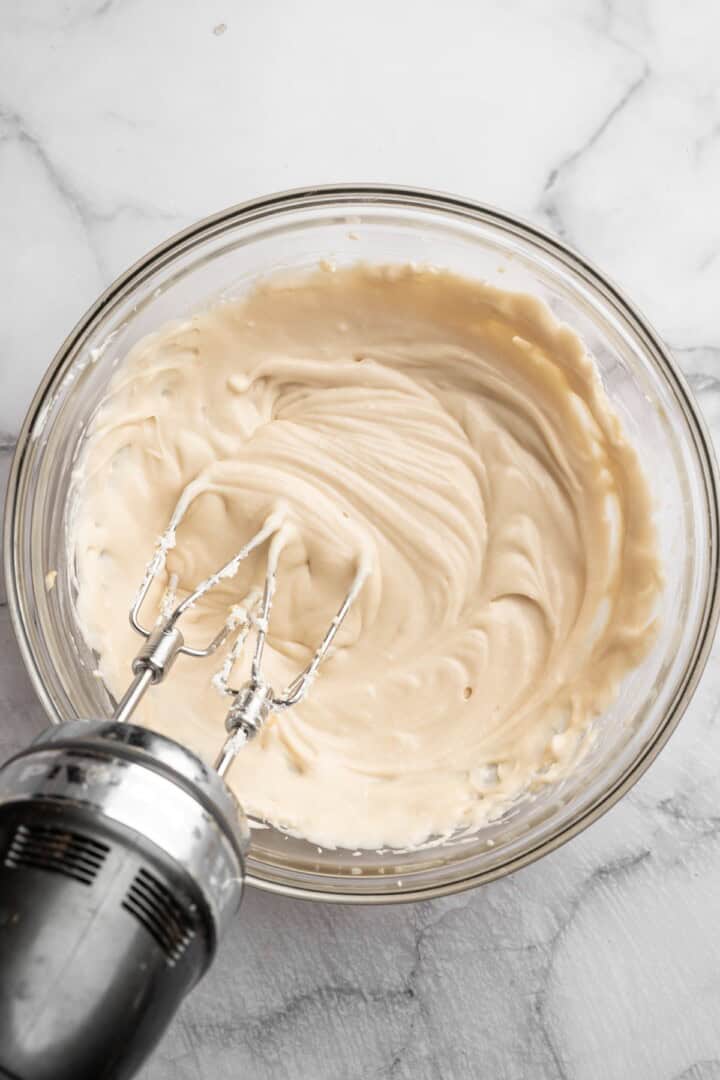 Mixing cheesecake filling with hand mixer