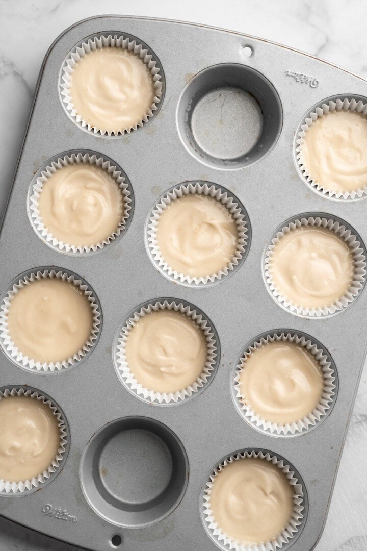 Overhead view of cheesecake mixture added to cupcake pan